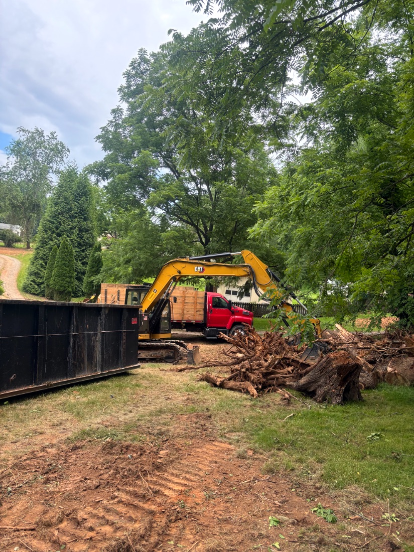 Excavator loading a debris container on a Western North Carolina job site