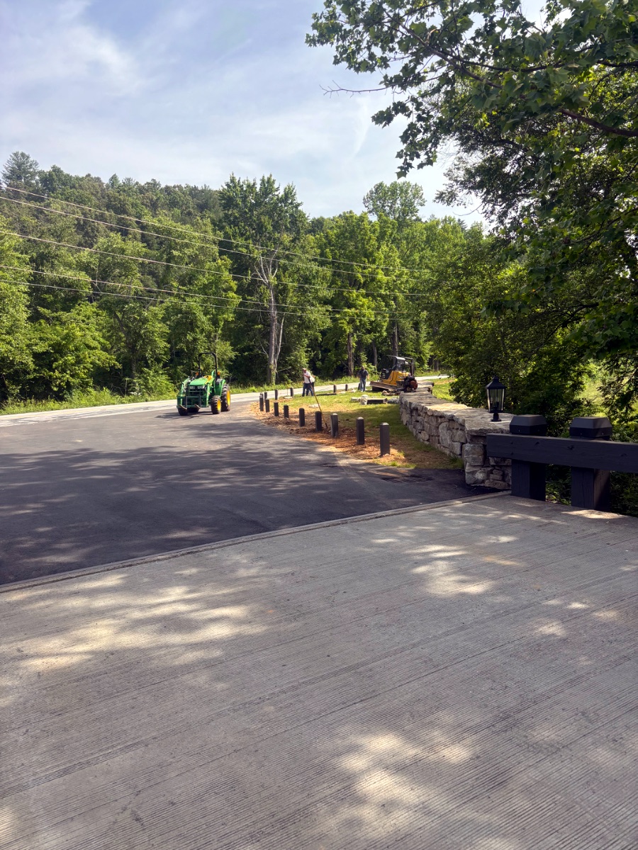 Finished asphalt driveway and stone retaining wall built in Western North Carolina