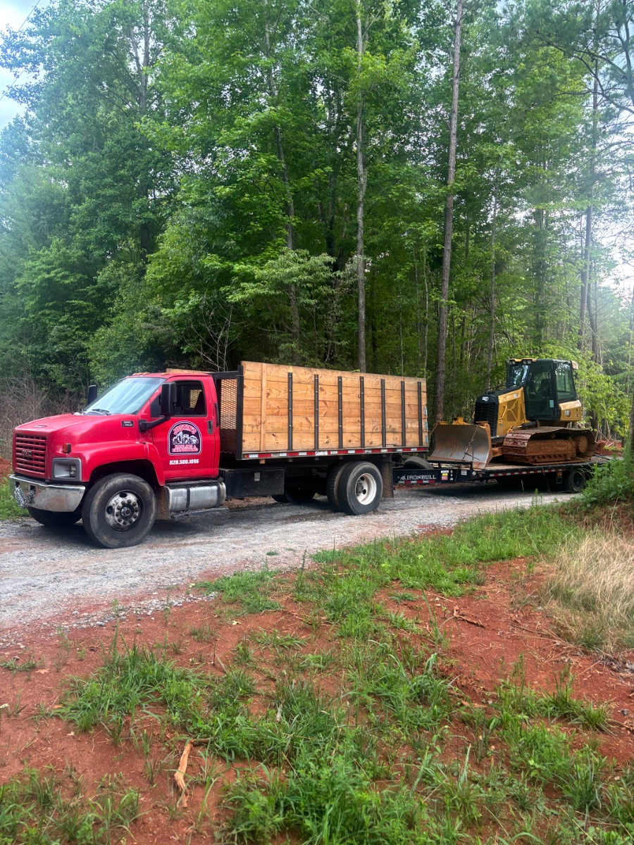 Dump truck and trailer hauling a CAT dozer