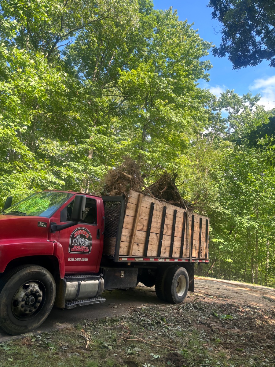 Loaded dump truck on a green job site in the Asheville, NC area